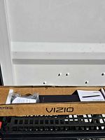 Sound bar in original open box with accessories and manual visible