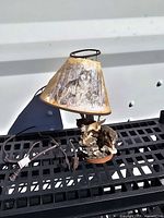 Full view of wolf-themed table lamp showing shade, base, cord