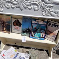 All five hardcover naval books on shelf