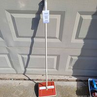 Full view of Beaumark carpet sweeper standing upright