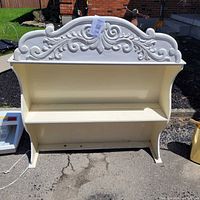 front view showing full shelf and decorative crest