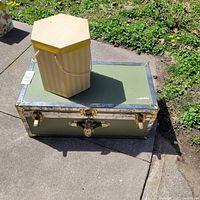 Full view of trunk and hat box outdoors