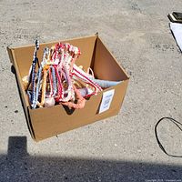 Box filled with colourful vintage hangers