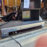 Front view of Samsung DVD player with CD racks stacked on top