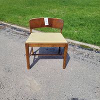 Front view of wood chair on pavement
