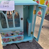 Front view with left door open showing interior compartments and drawers