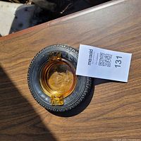 Top view of ashtray showing amber glass insert within rubber Firestone tire