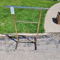 Full view of brass clothing stand