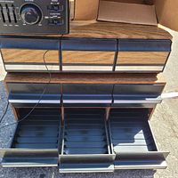 Casio stereo components resting on two faux-wood cassette drawer units with drawers open