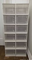 Front view showing twelve stacked shoe boxes with clear doors