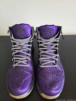 Front view of both shoes showing laces, tongues, and overall upper condition