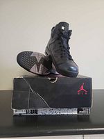 Sneakers on top of original Jordan box, side and sole view visible