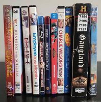 Front view of ten movie and TV disc cases standing upright showing titles and formats
