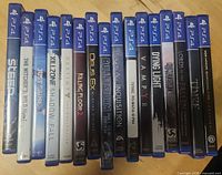 Front view of fifteen PS4 game cases showing spines and titles