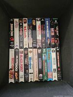Row of VHS tapes inside box showing titles