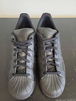 Top view of both shoes showing laces, tongue branding, shell toe