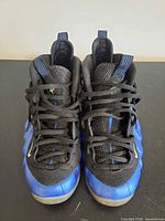 Pair of sneakers front view showing lacing, tongue, and royal blue shell