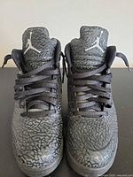 Front view of both shoes showing uppers, laces and Jumpman tongues