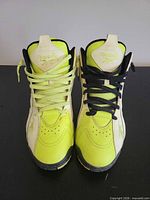 Top view of both sneakers showing colorway and mismatched laces