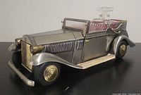 Three-quarter view of car decanter showing body, stopper and shot glasses