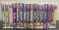 Spines of all 16 sealed Disney Masterpiece Collection VHS tapes lined up side by side