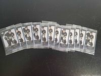 Front view showing all 11 sealed Sidney Crosby card packs fanned out