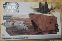 Front of sealed box showing Mandalorian artwork, vehicles, piece count 332, age 8+