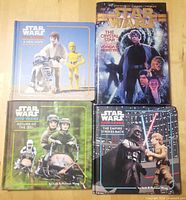 Four Star Wars books laid out: three children’s hardcovers and one paperback novel