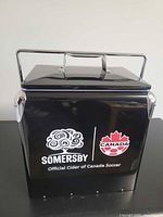 Front view showing logos, handle, and overall cooler design