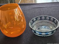 Orange tumbler and clear/blue dish side by side
