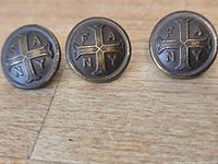 front view of three FANY buttons showing emblem