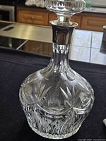 Full view of cut crystal mallet decanter with sterling collar and stopper