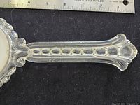 Handle close-up showing lucite material and oval cut-outs