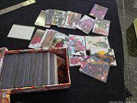 Open box showing quantity of sleeved artist trading cards with abstract artwork
