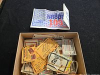 Top view of open box showing assorted Nabob and Blue Ribbon coupons