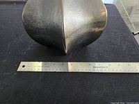 Side view of burner next to ruler showing width about 8 in.