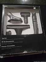 Front of Dyson tool kit box showing five included attachments in display window