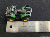 Top view of John Deere ATV beside ruler