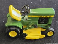 Left side view of John Deere 70 model tractor with ruler for scale