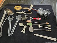 assorted utensils laid out on black cloth