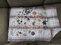 Entire assortment of jewellery laid out on towel