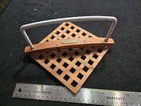 Top view showing teak lattice structure, white handle and ruler for scale