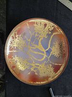 Top view showing orange-red and lavender enamel with gold pattern