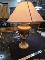 Full view of hammered metal lamp with shade