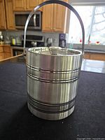 Full view of stainless steel paint can ice bucket with lid and handle