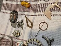 Group view showing majority of jewellery and curios on cloth