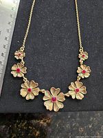 Necklace close-up showing floral stations and rhinestones