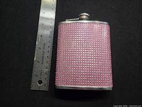 Front view of flask beside ruler showing height and width