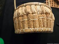 Side view showing corn cob exterior and raffia weaving