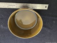 Top view of round olive-brown glazed dish